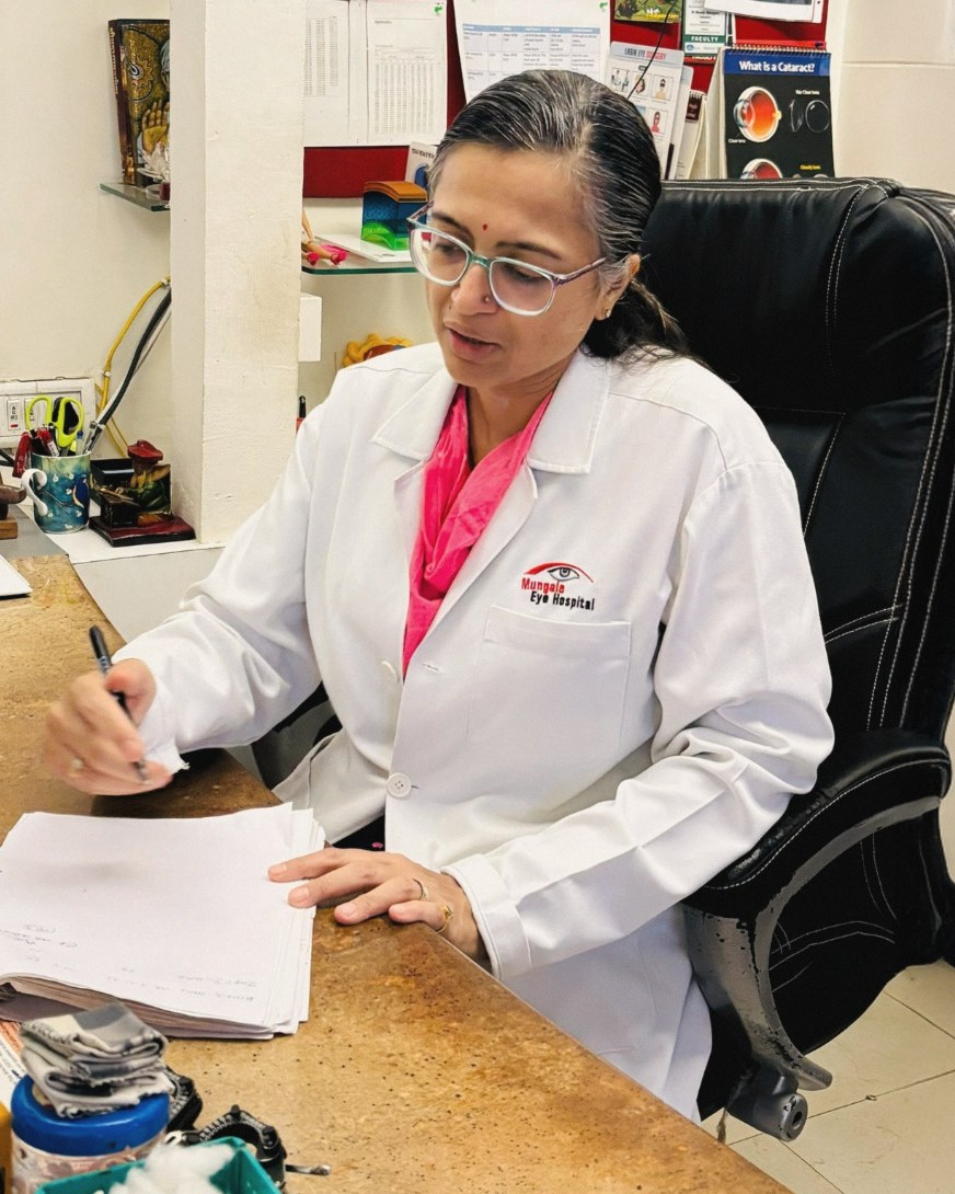 Dr. Meeta Mungale writing at her desk